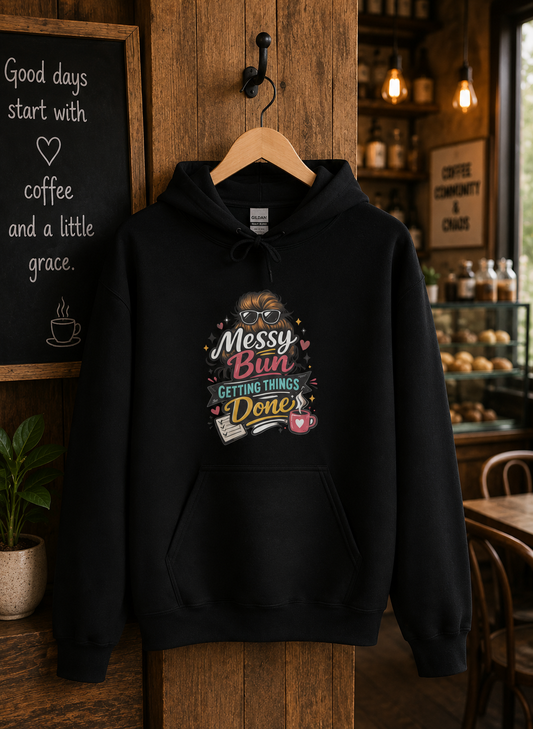 Black Messy Bun, Mission Done hoodie displayed on a wooden hanger