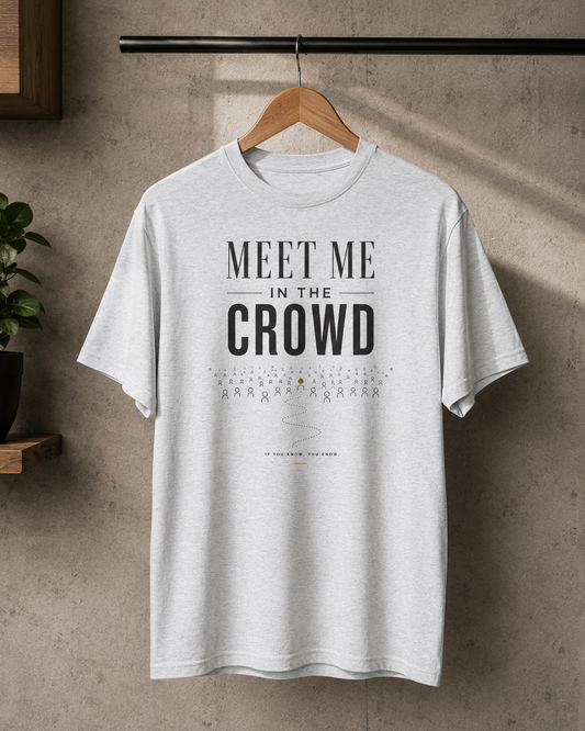 White Meet Me in the Crowd graphic T-shirt displayed on a hanger