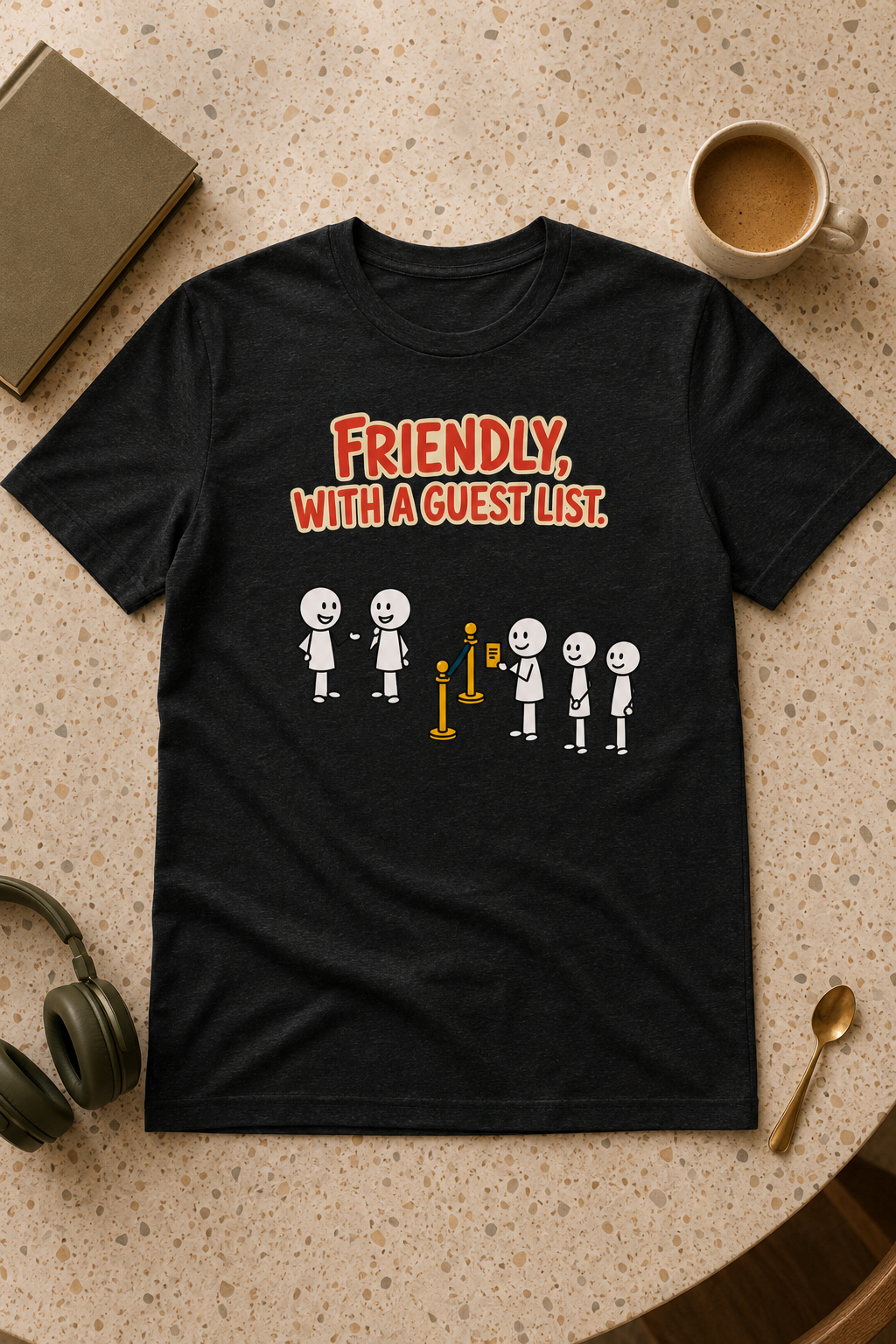 The Guest List black unisex T-shirt flat lay with coffee, book and headphones
