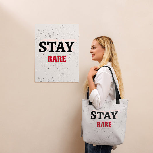 Woman carrying a white Stay Rare graphic tote bag