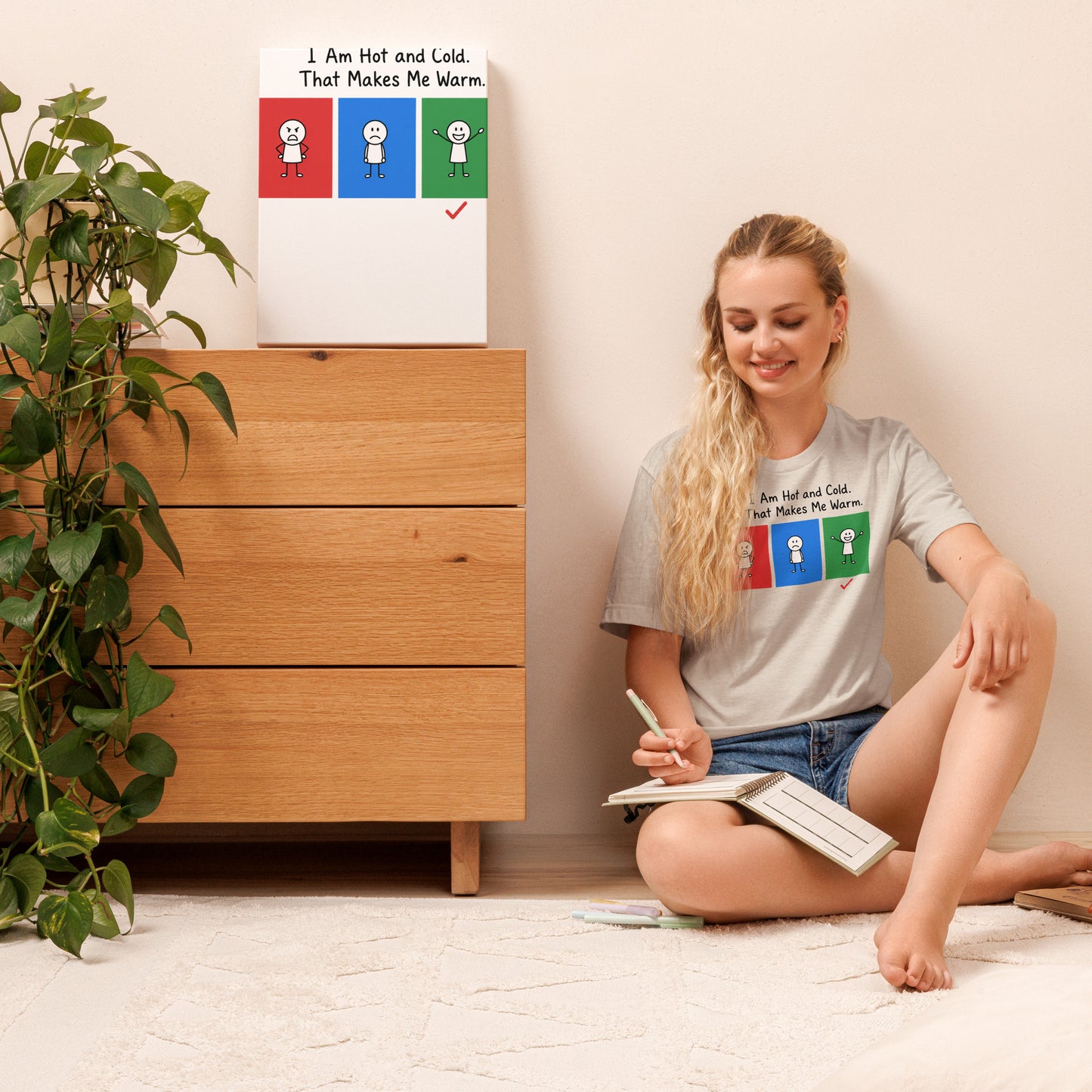 Woman wearing the Hot, Cold & Perfectly Warm graphic T-shirt while writing at home